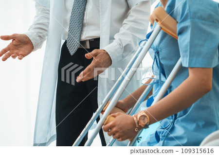 Doctor takes care of patient in crutch at hospital Jivy 109315616