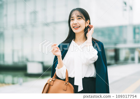 Businesswoman with office building in the background 109317754