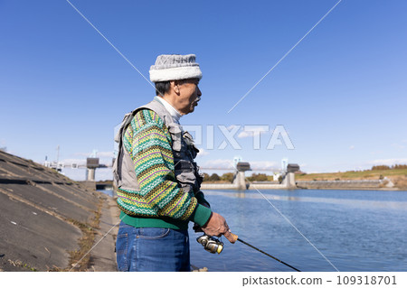 Senior man enjoying his hobby of fishing Senior man enjoying his hobby of fishing 109318701
