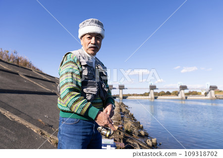 Senior man enjoying his hobby of fishing 109318702