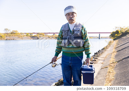 Senior man enjoying his hobby of fishing Senior man enjoying his hobby of fishing 109318709