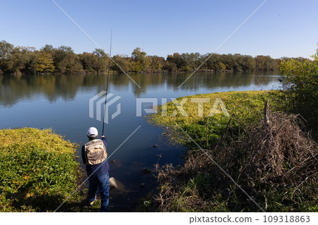 A man enjoying his hobby of fishing in nature A man enjoying his hobby of fishing in nature 109318863