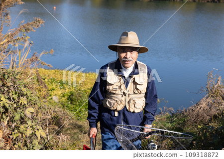 A man enjoying his hobby of fishing in nature 109318872