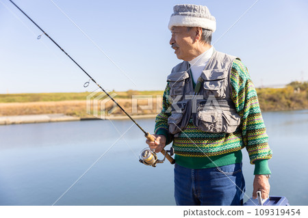 Senior man enjoying his hobby of fishing 109319454