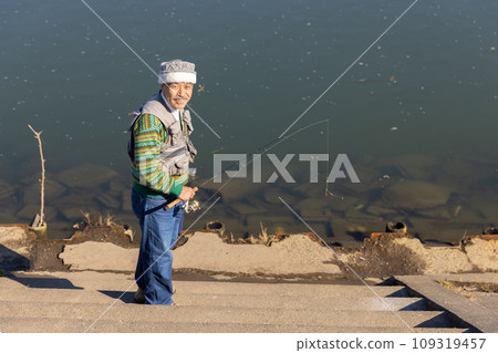 Senior man enjoying his hobby of fishing Senior man enjoying his hobby of fishing 109319457