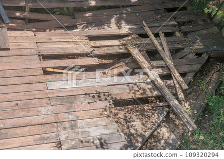 Wooden deck damaged due to aging Wooden deck damaged due to aging 109320294