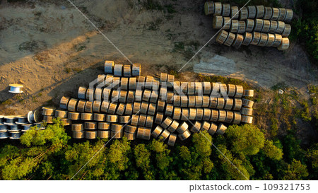 Wooden Coils of Electrical wires at outdoor construction site. High voltage cable roll. Wooden Coils of Electrical wires at outdoor construction site. High voltage cable roll. 109321753