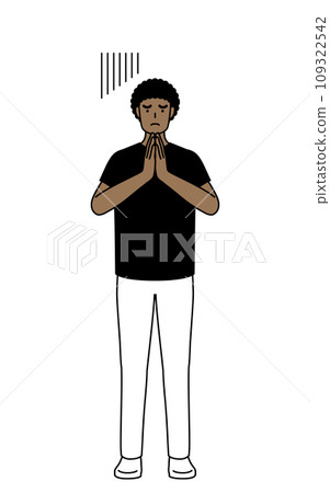African man apologizes by putting his hands together in front of his body 109322542