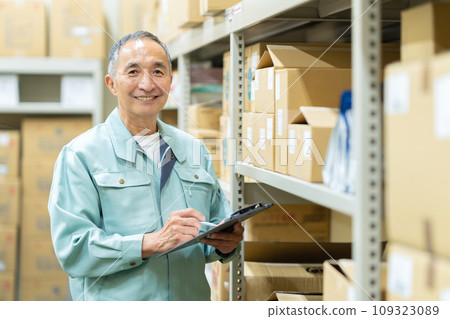 Senior male worker inspecting items in a warehouse Senior male worker inspecting items in a warehouse 109323089