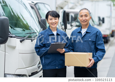 Middle-aged male and female drivers delivering cargo by truck 109323113