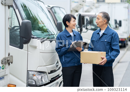 Middle-aged male and female drivers delivering cargo by truck 109323114