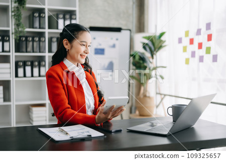 Woman freelancer is working her job on computer tablet and laptop Doing accounting analysis report real estate investment data, Financial at office. 109325657