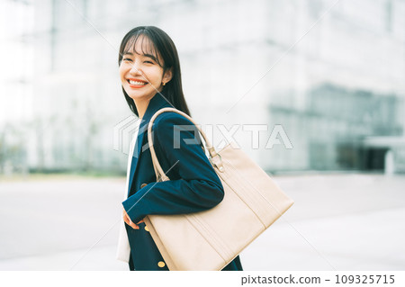 Businesswoman with office building in the background Businesswoman with office building in the background 109325715