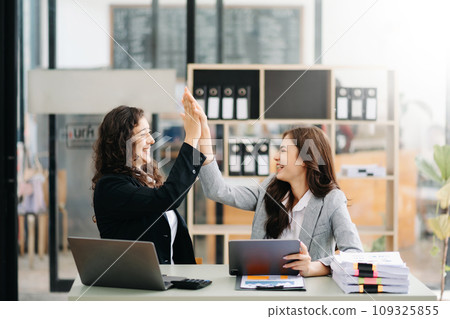 Young business team creative businesspeople coworker, teamwork celebrating achievement and in planning design in creative in modern office 109325855