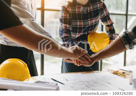 Engineers or architecture shaking hands at construction site for architectural project, holding safety helmet on their hands. successful cooperation concept. 109326280