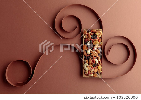 The mix of dried fruits and berries on a brown background. 109326306