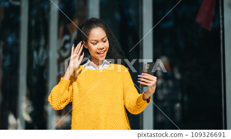 Working woman concept a female manager attending video conference and holding tablet, smatrphone and  cup of coffee on street in city Outside . 109326691