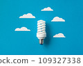 Light bulb with white cut out clouds. Idea concept 109327338