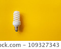 Energy saving light bulb on a orange background 109327343
