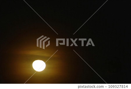 bright yellow full moon floating on dark sky in the night 109327814