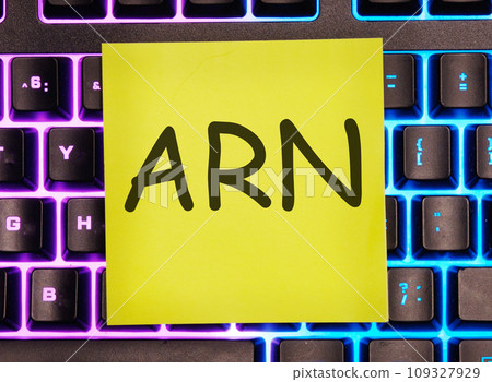 ARN as Account Reference Number written on a yellow sticker on a laptop keyboard with backlight ARN as Account Reference Number written on a yellow sticker on a laptop keyboard with backlight 109327929