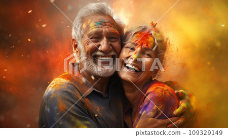 An elderly couple - a man and a woman with joyful faces at the celebration of the Holi festival.  109329149