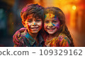 A boy and a girl with joyful faces at the celebration of the Holi festival.  109329162