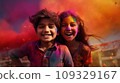 A boy and a girl with joyful faces at the celebration of the Holi festival.  109329167