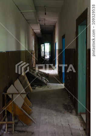 Dark corridor in abandoned building of former House of Culture in resettled village of Pogonnoye in exclusion zone of Chernobyl, Belarus 109329538