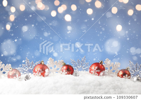 Christmas balls and snowflake with snow on color background Christmas balls and snowflake with snow on color background 109330607
