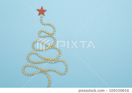 Christmas tree yellow garland on color background Christmas tree yellow garland on color background 109330658
