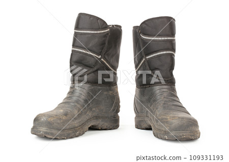 Dirty insulated old boots on a white background. Hiking boots. 109331193