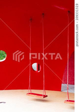 red swing with red background 109331319