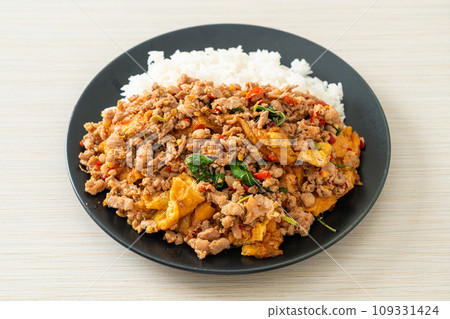 stir-fried minced pork with basil and egg topped on rice stir-fried minced pork with basil and egg topped on rice 109331424