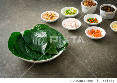 Miang kham - A royal leaf wrap appetizer Miang kham - A royal leaf wrap appetizer 109331554