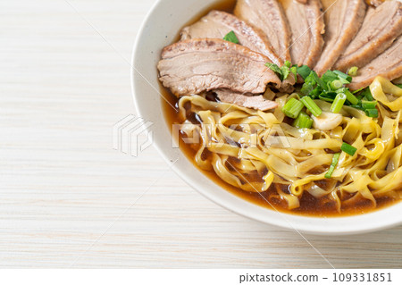 egg noodles with stewed duck in brown soup 109331851
