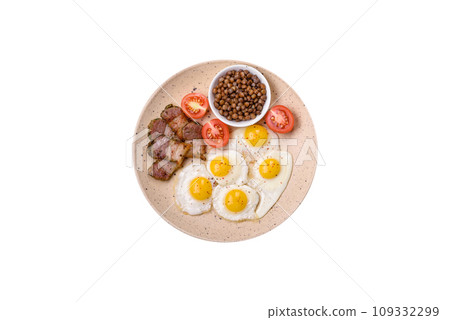 Delicious nutritious breakfast of fried quail eggs, bacon, legumes and cherry tomatoes Delicious nutritious breakfast of fried quail eggs, bacon, legumes and cherry tomatoes 109332299