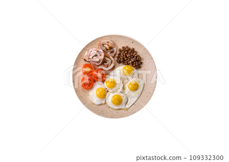 Delicious nutritious breakfast of fried quail eggs, bacon, legumes and cherry tomatoes Delicious nutritious breakfast of fried quail eggs, bacon, legumes and cherry tomatoes 109332300
