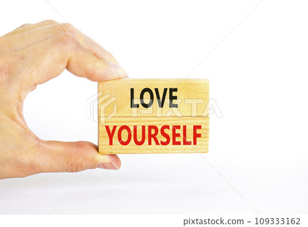 Love yourself symbol. Concept words Love yourself on beautiful wooden blocks. Beautiful white table white background. Psychologist hand. Psychology love yourself concept. Copy space. 109333162