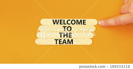 Welcome to the team symbol. Concept words Welcome to the team on beautiful wooden stick. Beautiful orange table background. Businessman hand. Business, motivational and welcome to the team concept. Welcome to the team symbol. Concept words Welcome to the team on beautiful wooden stick. Beautiful orange table background. Businessman hand. Business, motivational and welcome to the team concept. 109333218