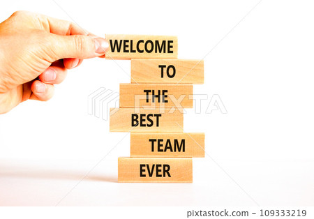 Welcome to best team symbol. Concept words Welcome to the best team ever on wooden block. Beautiful white table background. Businessman hand. Business motivational and welcome to best team concept 109333219