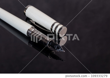 Fountain pen on marble and gray background. Gift concept. Fountain pen on marble and gray background. Gift concept. 109333279