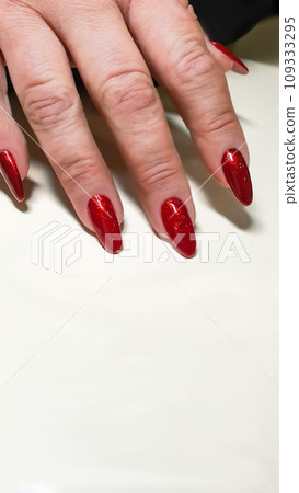 Manicure and nail extensions with acrylic and gel. The design is made with shiny gel polishes. Manicure and nail extensions with acrylic and gel. The design is made with shiny gel polishes. 109333295
