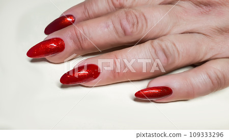 Manicure and nail extensions with acrylic and gel. The design is made with shiny gel polishes. Manicure and nail extensions with acrylic and gel. The design is made with shiny gel polishes. 109333296