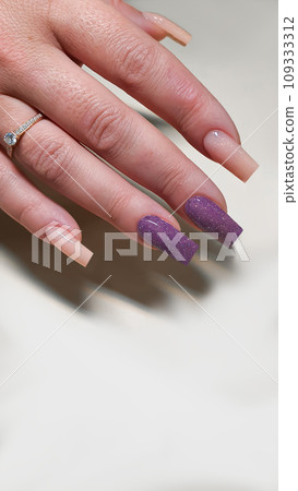 Manicure and nail extensions with acrylic and gel. The design is made with shiny gel polishes. 109333312