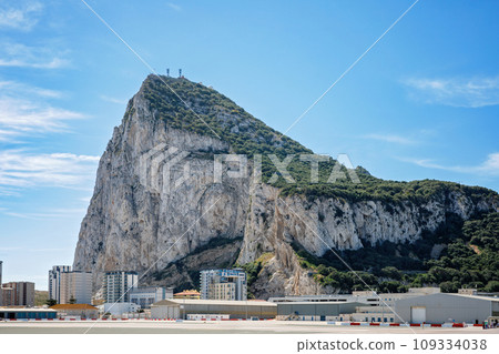 Road to the Rock of Gibraltar with marina on the left and town behind, view from La Linea, Spain 109334038