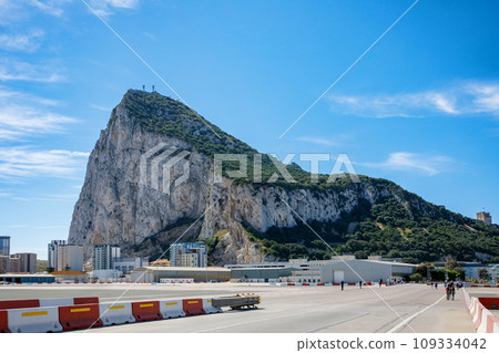 Road to the Rock of Gibraltar with marina on the left and town behind, view from La Linea, Spain Road to the Rock of Gibraltar with marina on the left and town behind, view from La Linea, Spain 109334042