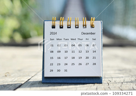 December 2024 white calendar with green blurred background. New year concept. 109334271