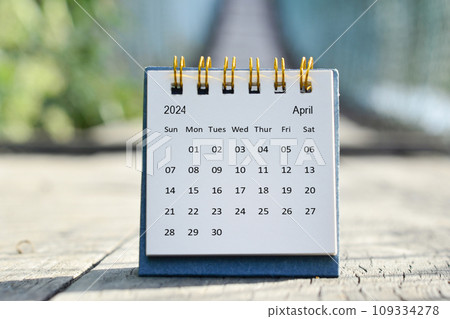 April 2024 white calendar with green blurred background. New year concept. 109334278