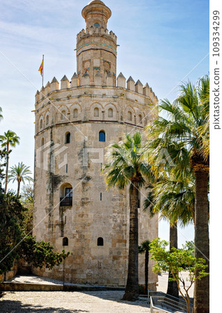 View of the Torre del Oro in Seville, Andalusia, Spain over the Guadalquivir river on sunny day 109334299